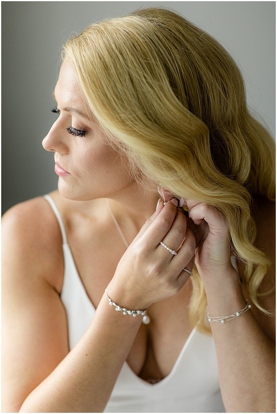 bride putting on earrings for wedding at tabrizi's baltimore md
