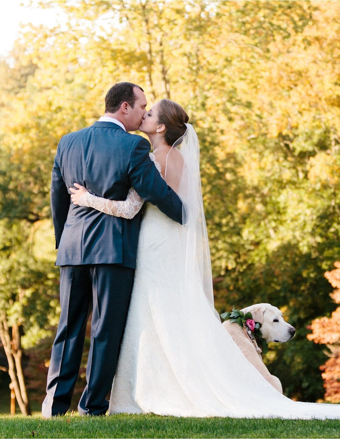 a bride and groom on their wedding day with their dog